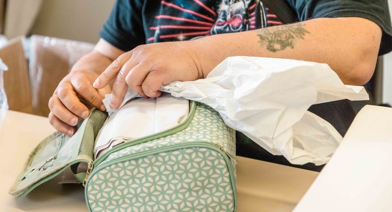 Kreative Beschäftigung im Grünthaler Hof Parkstein – Dr. Loew Einrichtung für Menschen mit psychischen Erkrankungen Detailaufnahme eines Klienten beim Verpacken eines Geschenks im Grünthaler Hof Parkstein